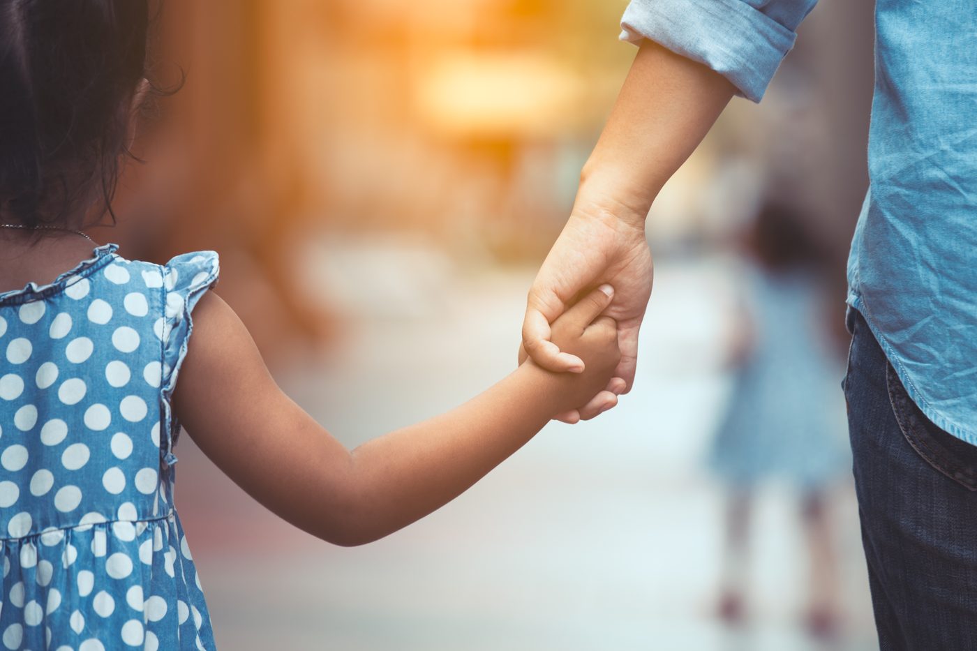 Mother and daughter holding hands