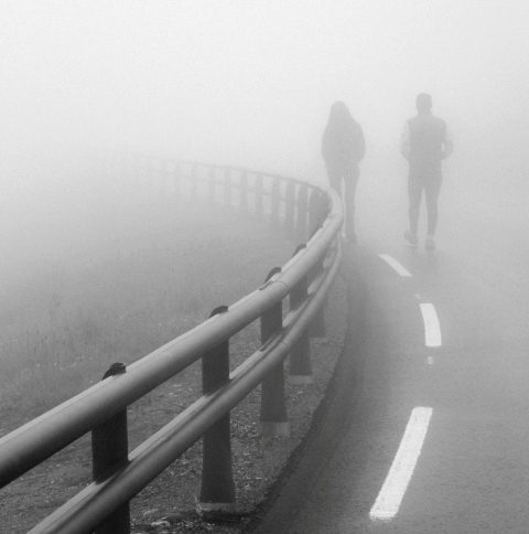 Couple walking in the fog