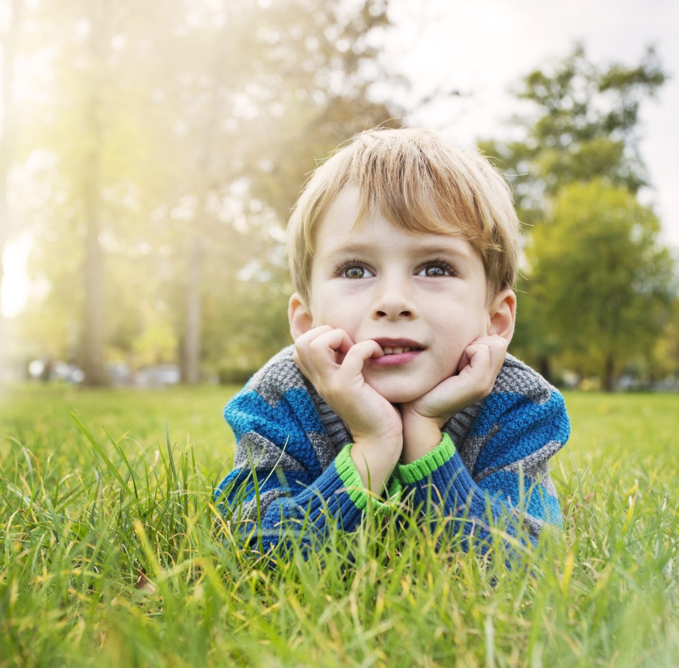 Boy laying in grass