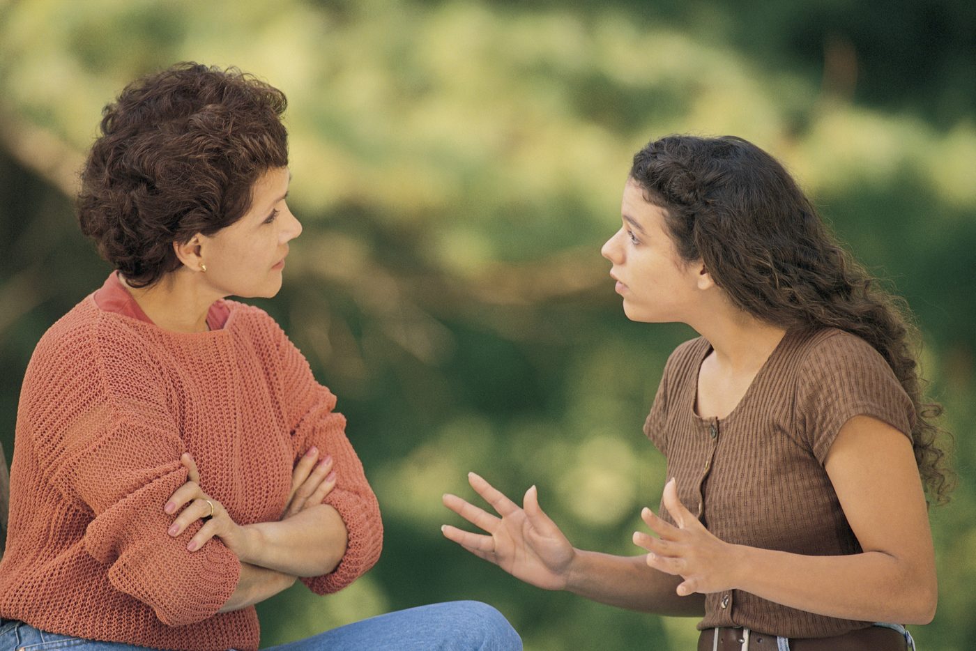 Mother and daughter arguing outside