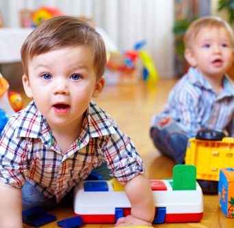 Curious toddlers with toys