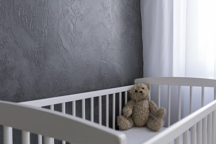 teddy bear in gloomy crib