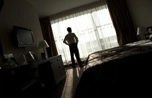 Man looking out hotel window