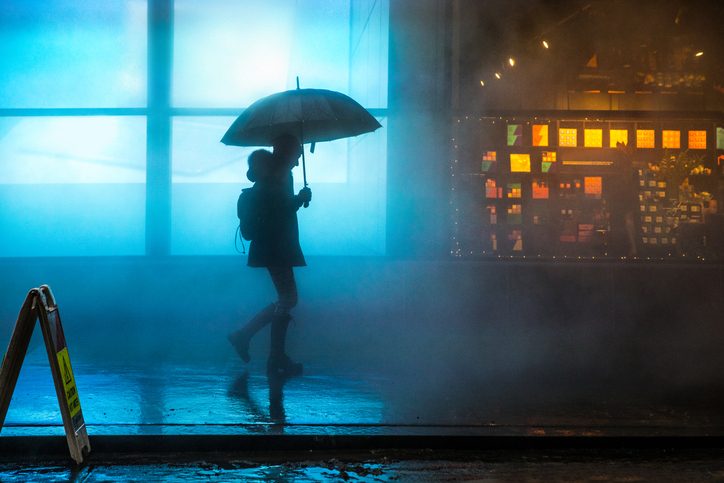 A person walks home alone in the rain