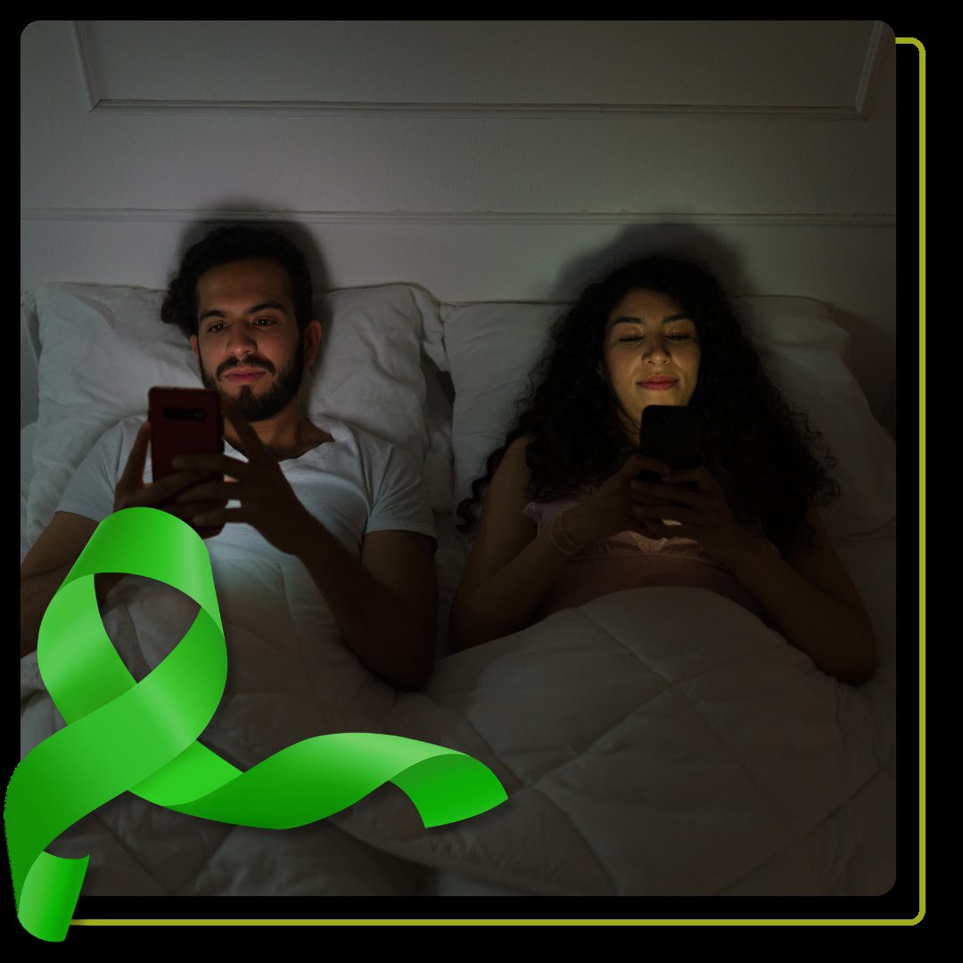 couple using their phones in bed