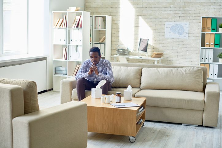 Man waiting in office for therapist