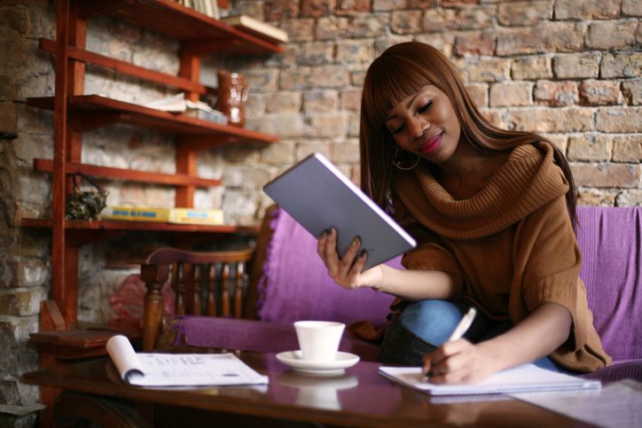 person taking notes in journal