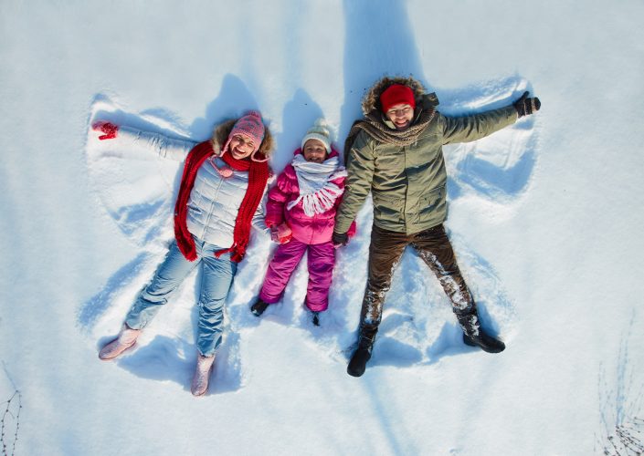 Family making snow angels