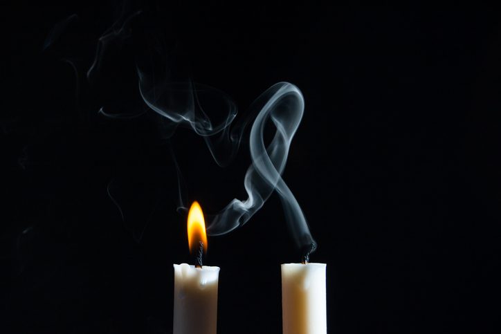 two candles, one lit