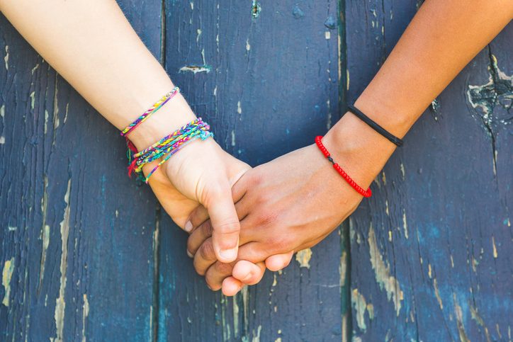 holding hands wearing bracelets
