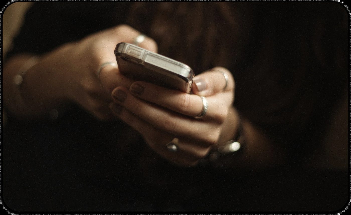 Hands holding smartphone, reflecting choice between doomscrolling and hope questing.