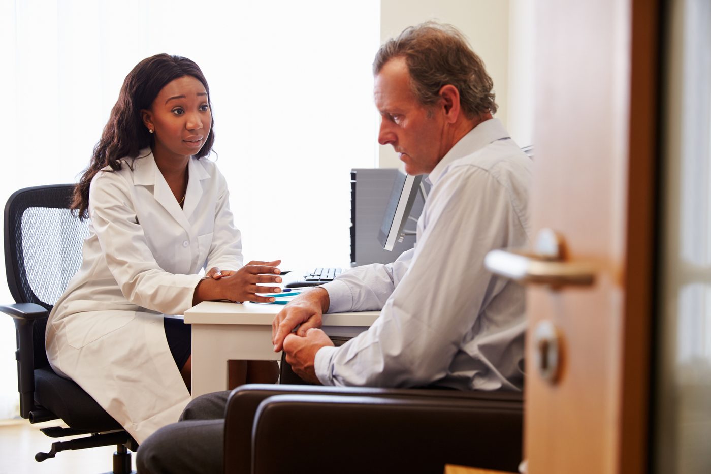 Female doctor treats a man with depression.