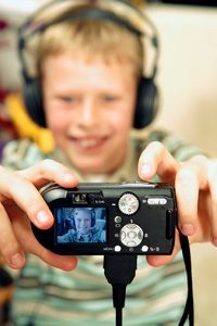 Boy using digital camera