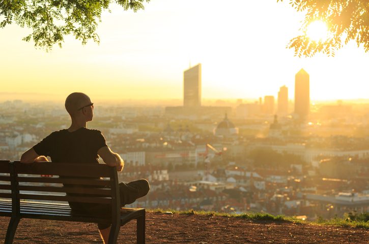 A man observes the city at dawn