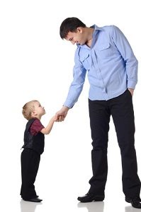 Blonde toddler boy shaking hands with dark-haired middle-aged man