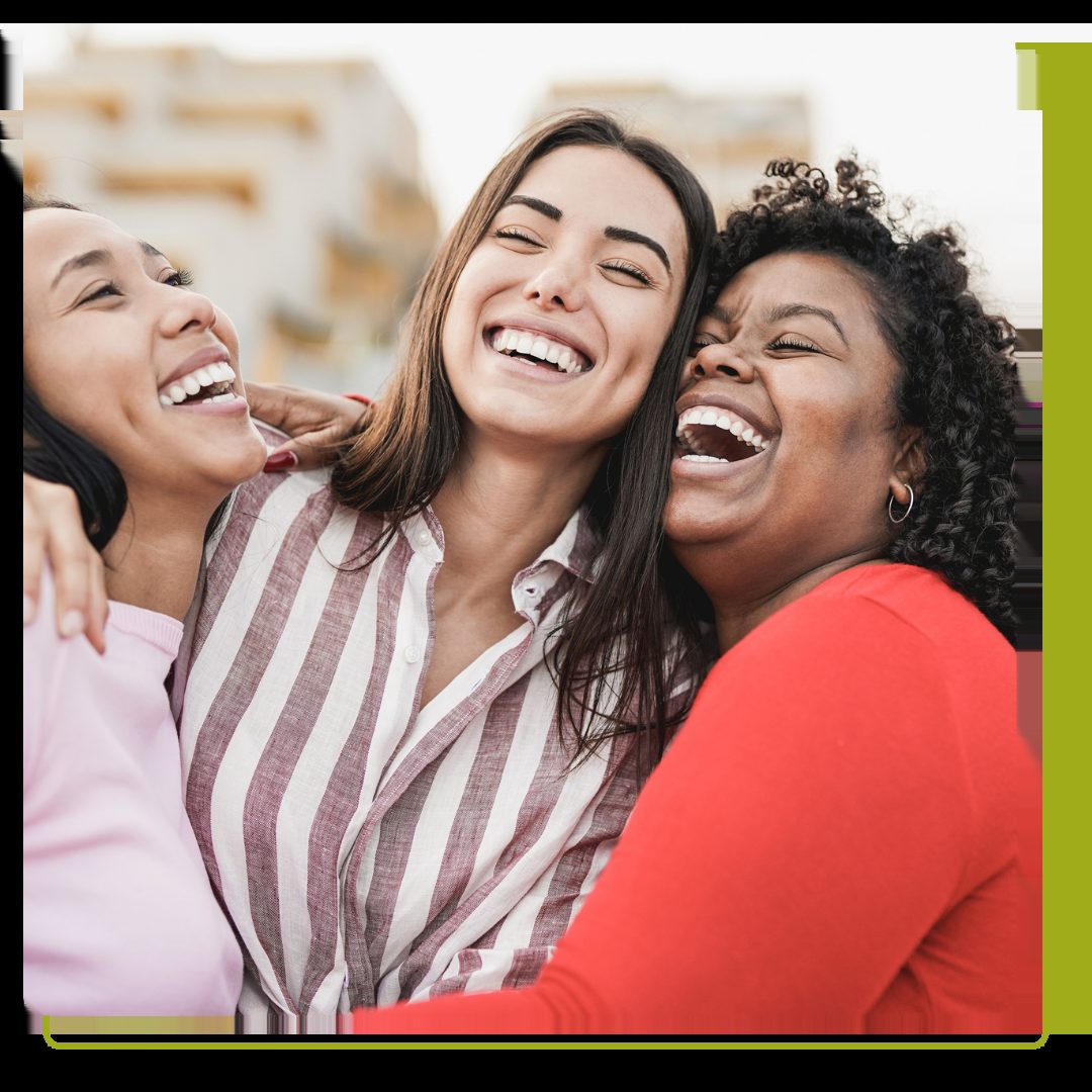 women laughing and hugging each other outdoor