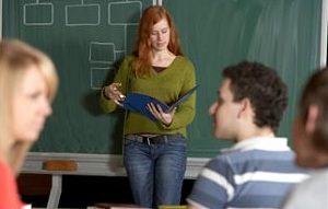 Woman giving report to class