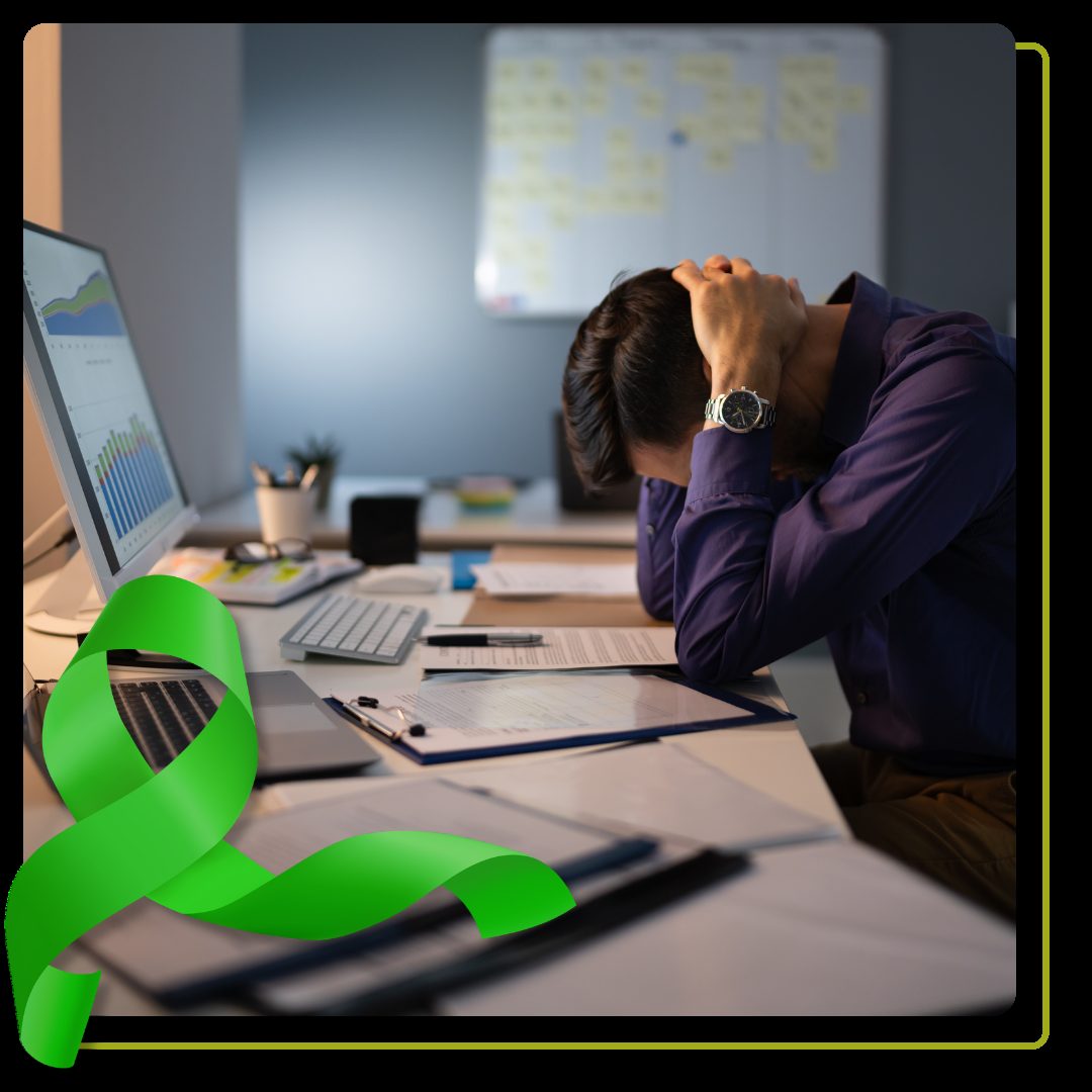 Stressed man in purple shirt in office setting