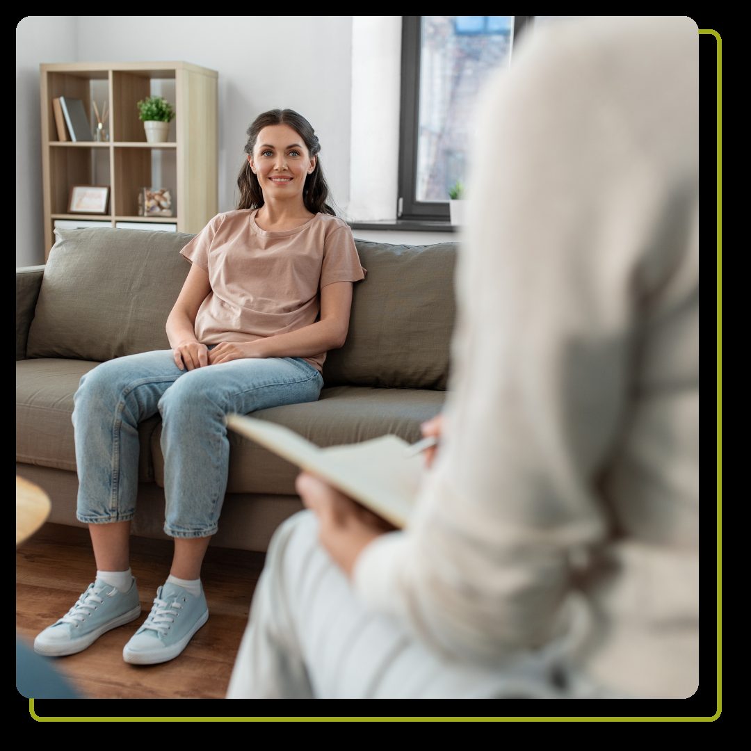 happy smiling young woman patient and woman psychologist at psychotherapy session