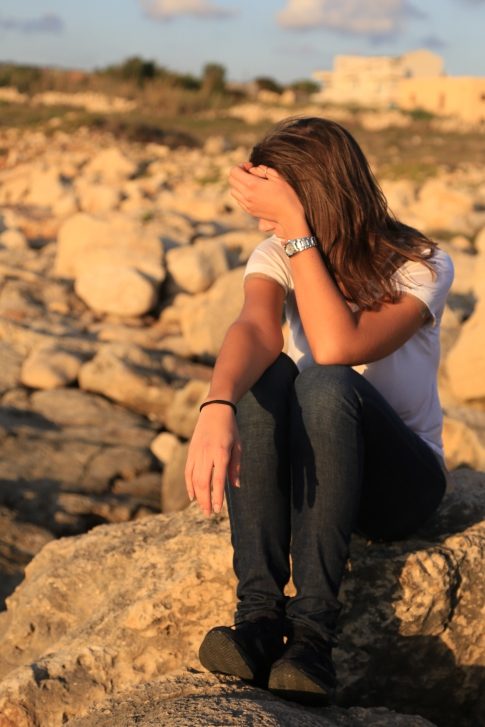 girl hiding face