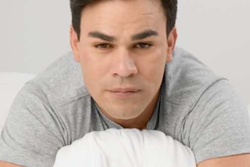 man hugging pillow