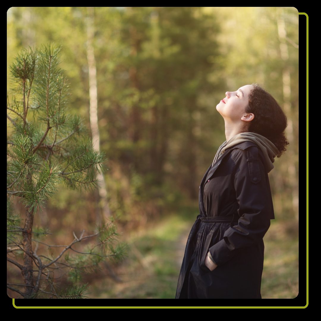 woman walking in forest and breathing fresh air