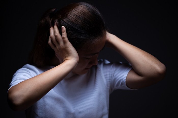 Woman covering her ears