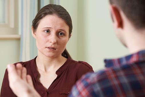 Depressed Young Woman Talking To Counselor
