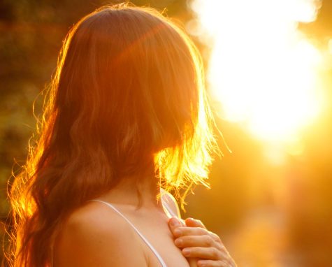 Young woman with hand over heart