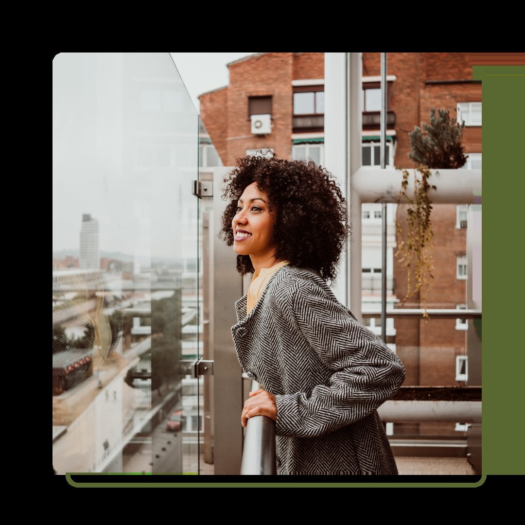 Woman looking over balcony on a building
