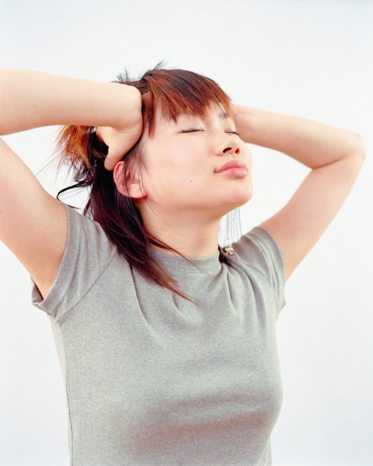 Woman with hands on head