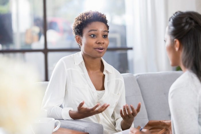 Woman motions while talking to therapist