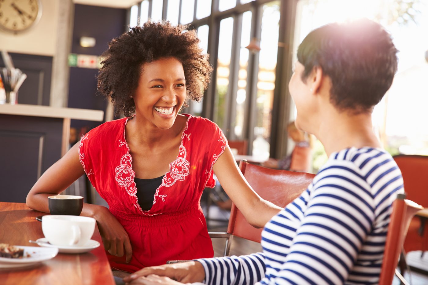 Two women talking at a coffee shop