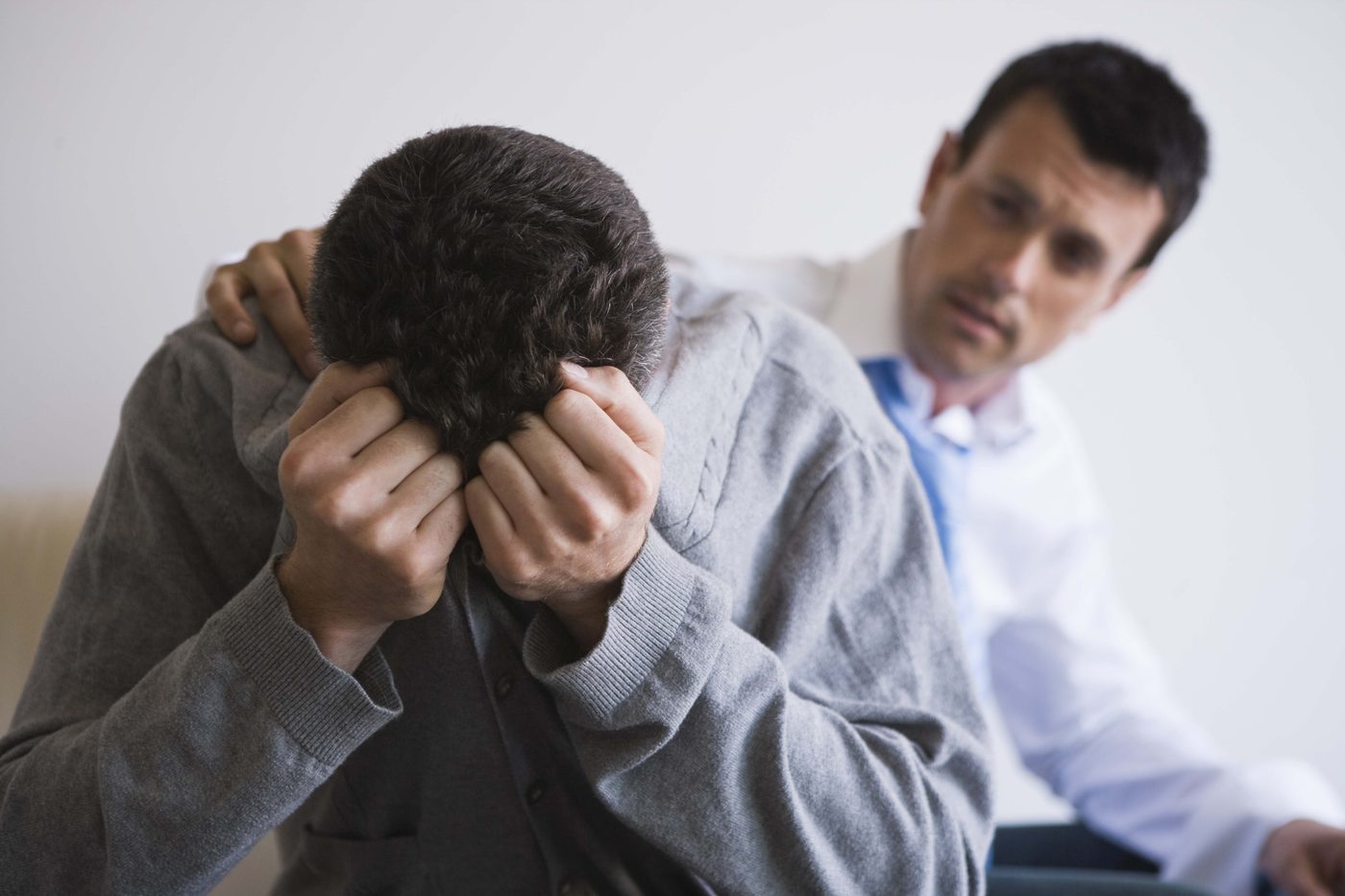 Man consoling friend