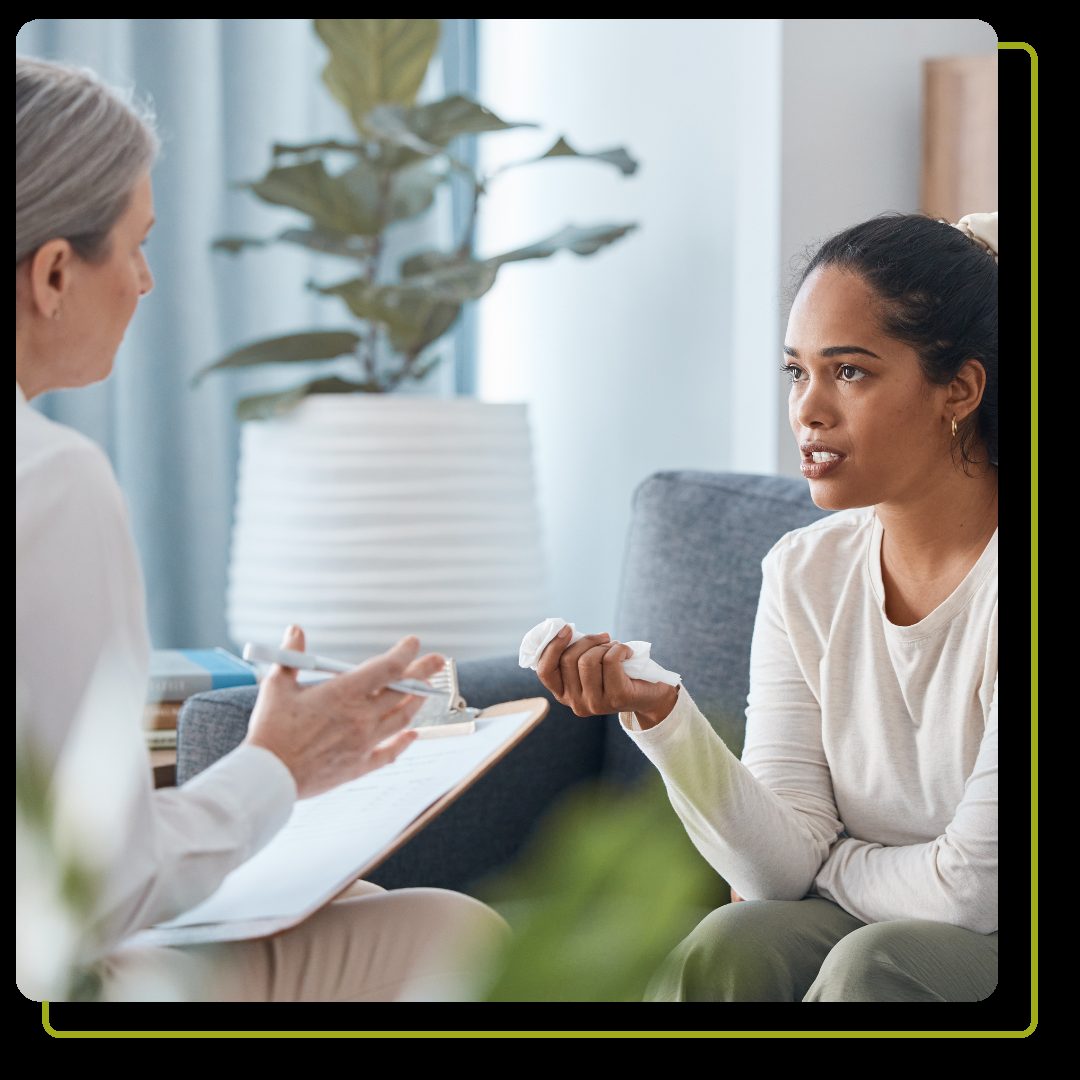 woman crying while talking with her therapist