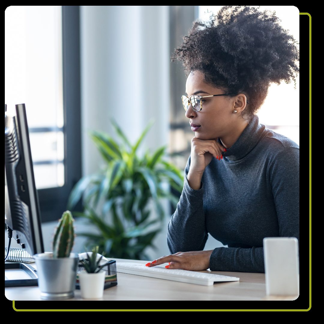 business woman working on computer while sitting in an office.