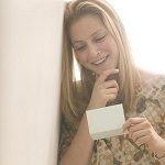 young woman reading card
