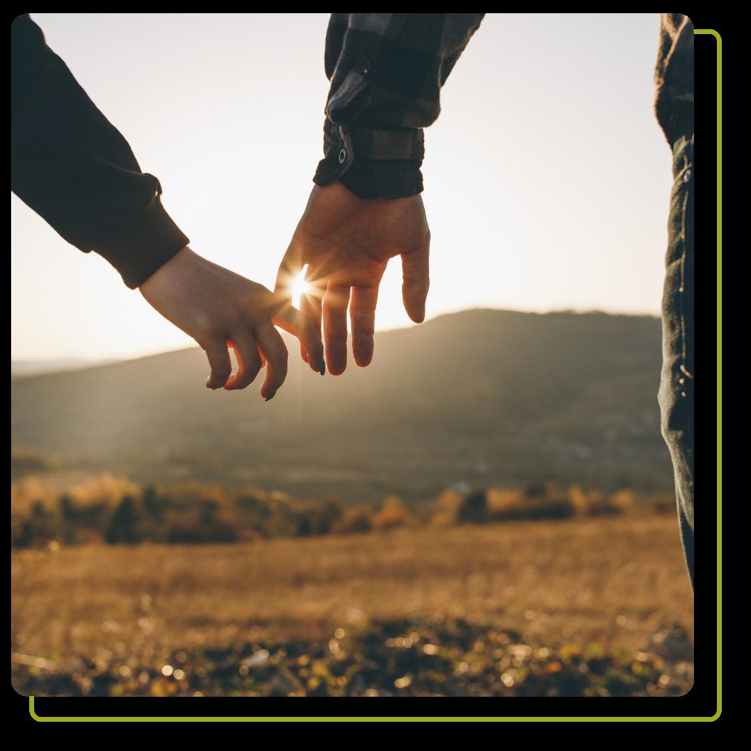 Couple holding hands in a field